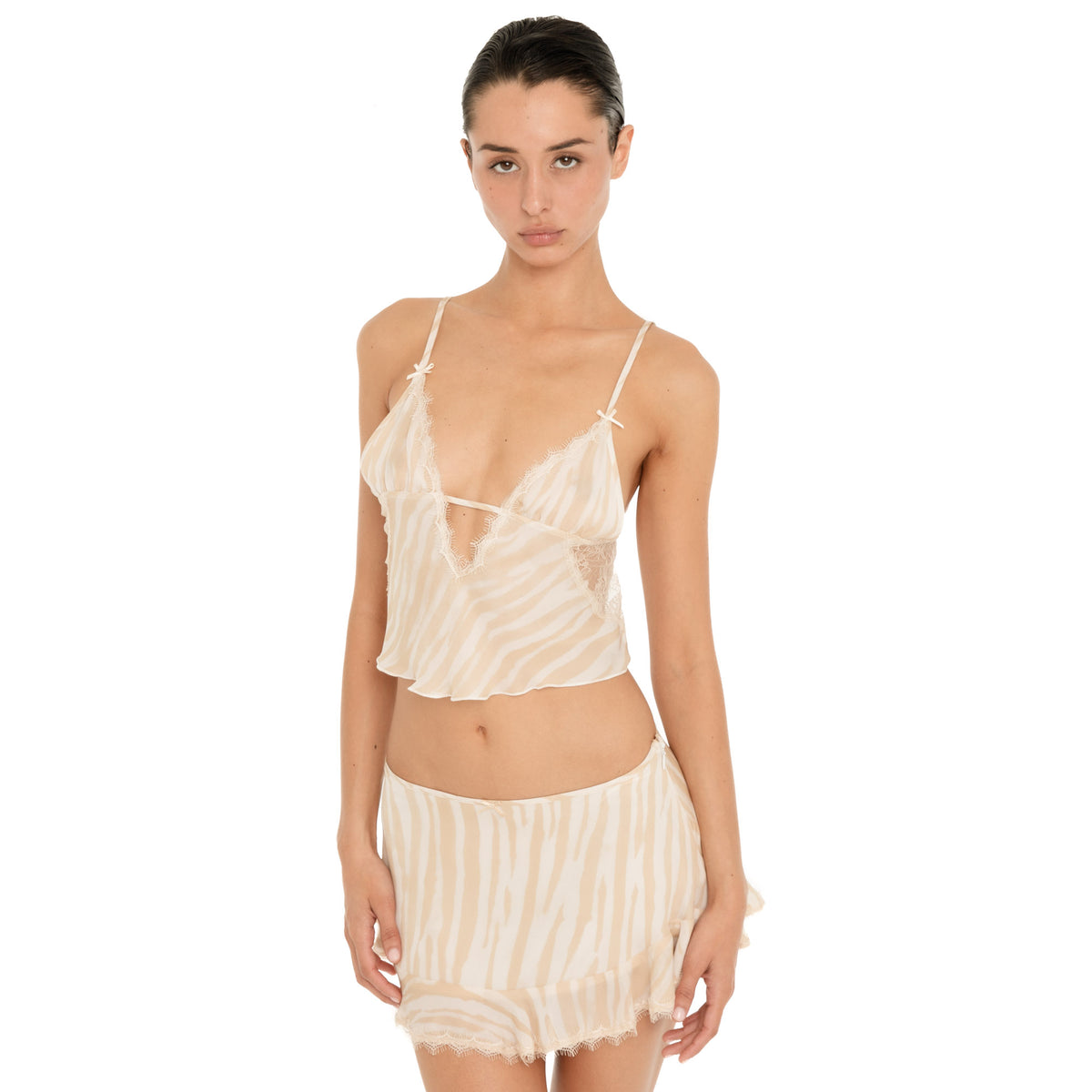 Model wearing the Are You Am I Aria Camisole in Ivory Latte with the matching skirt, showing the sheer zebra print, lace-trim neckline and cropped silhouette. **ivory-latte