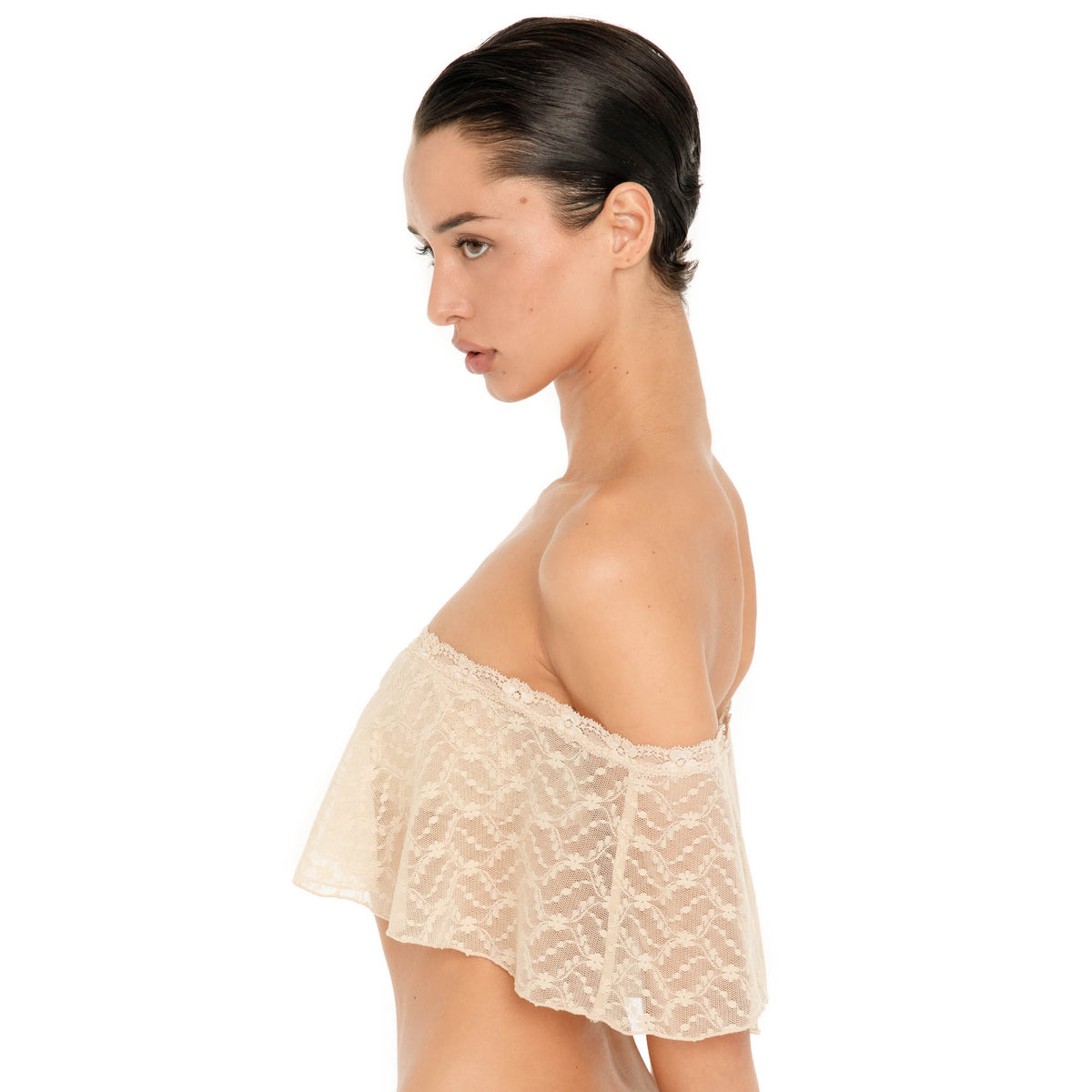 Side view of the Liulu Top in nude, showing the sheer floral lace, delicate trim and draped off shoulder ruffle. **nude