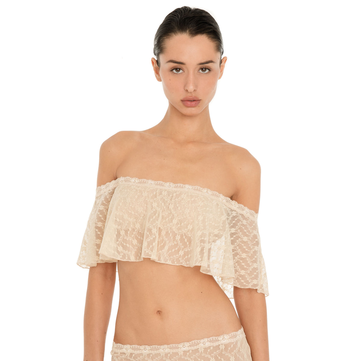 Front view of the Liulu Top in nude sheer lace, showing its cropped silhouette and soft off shoulder ruffle **nude