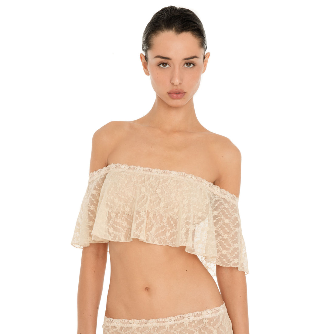 Front view of the Liulu Top in nude sheer lace, showing its cropped silhouette and soft off shoulder ruffle **nude
