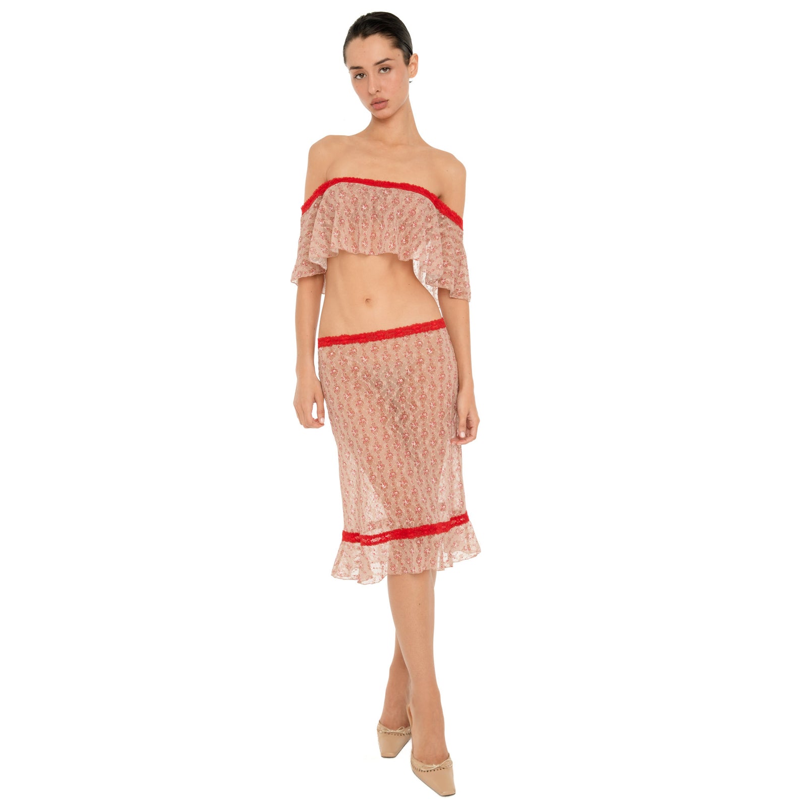 Full-length front view of a model wearing the Cherry Blossom Liulu Skirt, a sheer floral lace midi skirt with contrasting red lace trim, a low-rise waistband, and ruffled hem. **cherry blossom