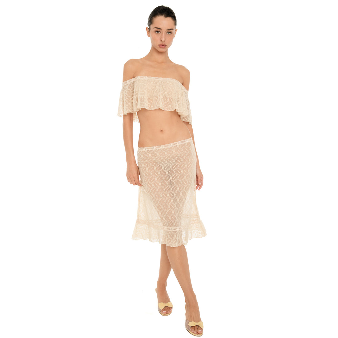 Front view of the Liulu skirt in nude, featuring sheer floral lace, a low rise fit, lace trimmed waistband, and ruffled midi hem. **nude