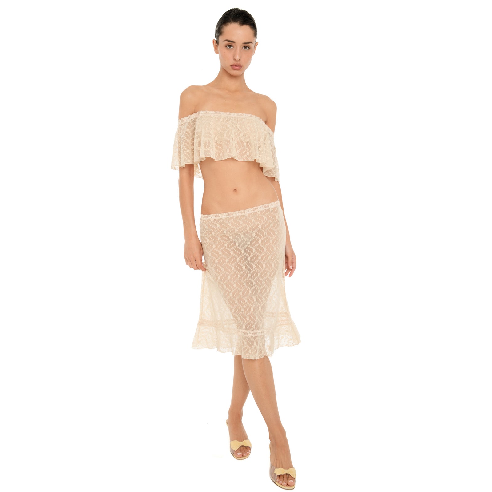 Front view of the Liulu skirt in nude, featuring sheer floral lace, a low rise fit, lace trimmed waistband, and ruffled midi hem. **nude