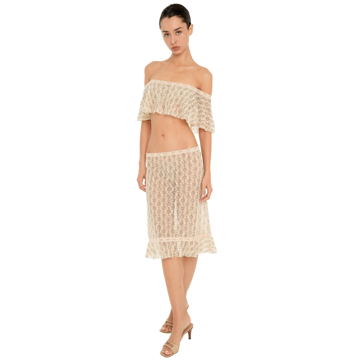 Front view of the Liulu skirt, featuring sheer floral lace, a fitted low-rise silhouette, delicate lace waistband, and ruffled midi hem. **sky blossom