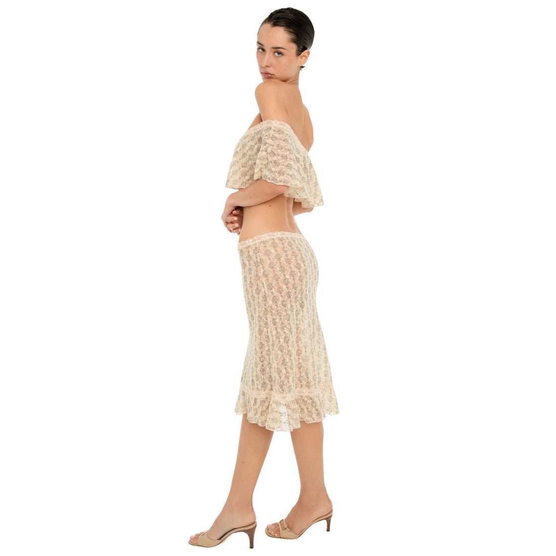 Side view of the Liulu skirt showing its fitted sheer floral lace silhouette, low-rise waist, and flared ruffle along the hem. **sky blossom
