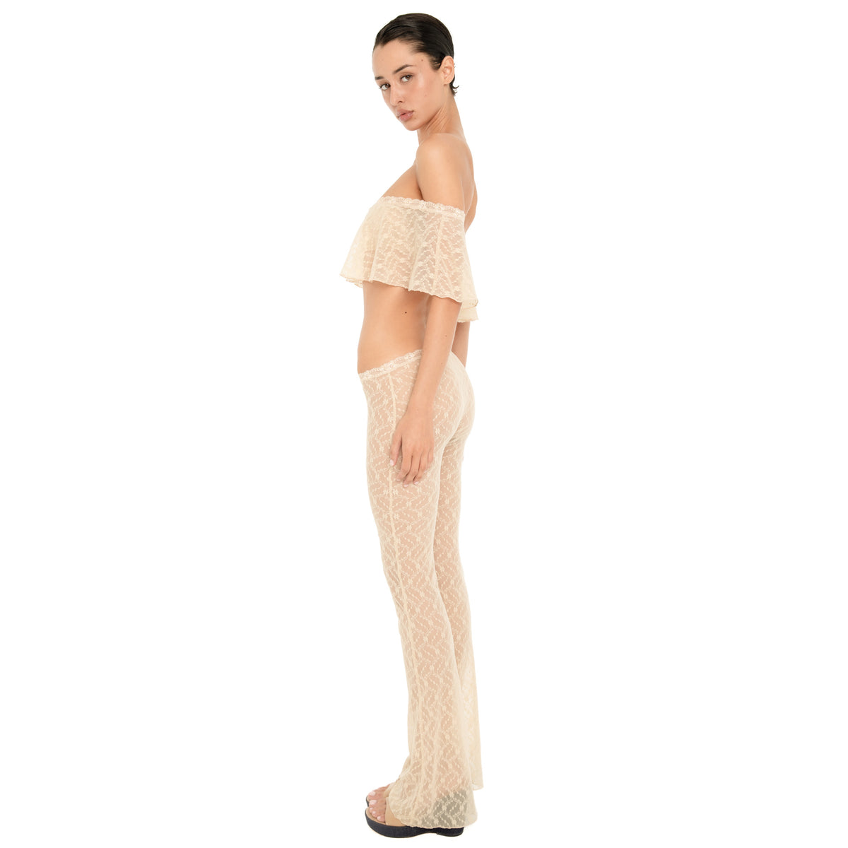 Side view of the Liani Pant in Nude, showing the low rise lace waistband, sheer floral lace and flared hem. **nude