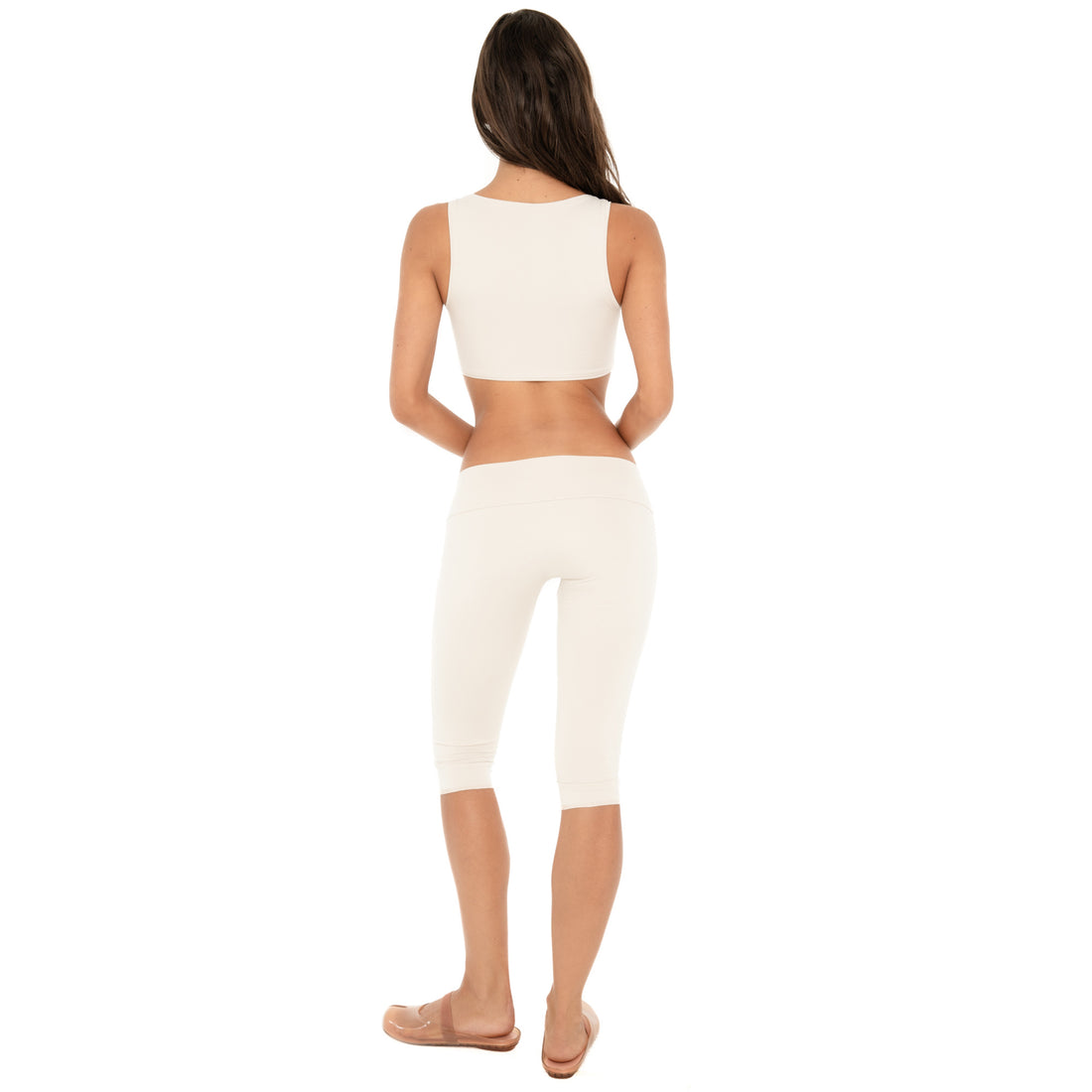 Back view: Back view of the sand Clio Capri, showing the low-rise fold-over waistband and fitted shape through the hips and legs **sand