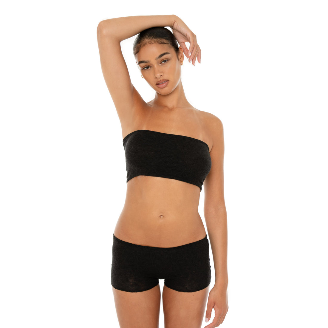 Front view of the Aili Tube in black styled with matching low rise shorts, showing the soft ribbed texture and cropped fit **black
