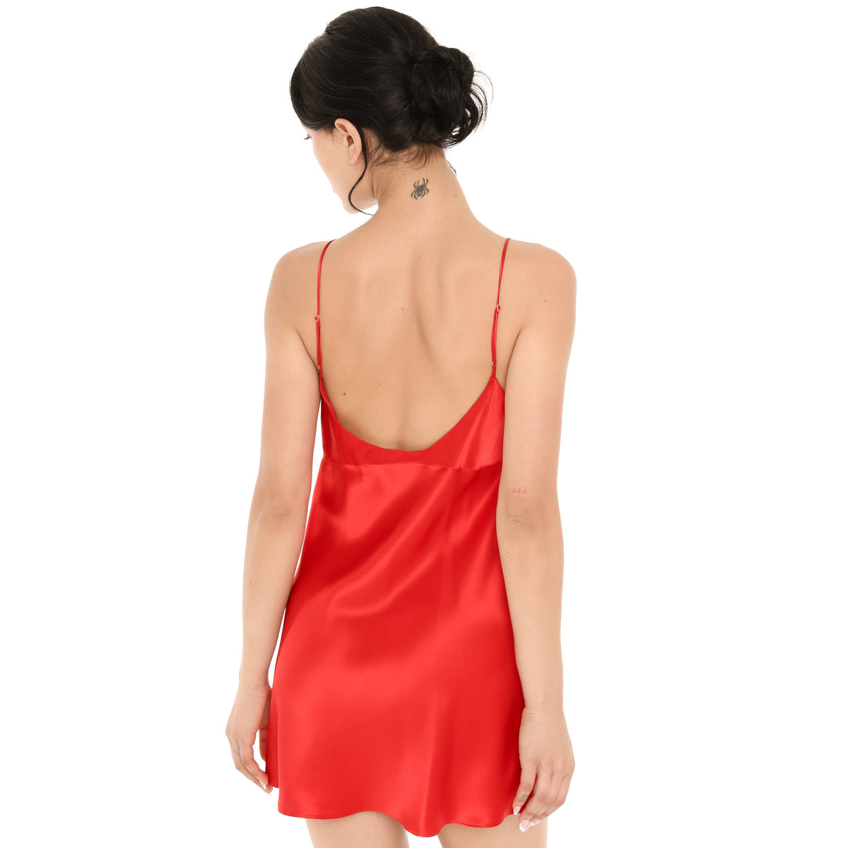 Back view of the cherry red silk Eisling Dress, showing the low scoop back and thin straps with small gold adjusters. **cherry red
