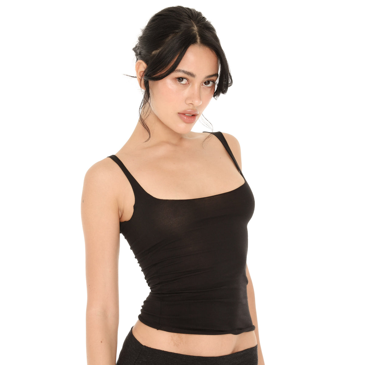Three-quarter view of the black Elix Tank, showing the square neckline, the wide straps and the close fit through the waist **black