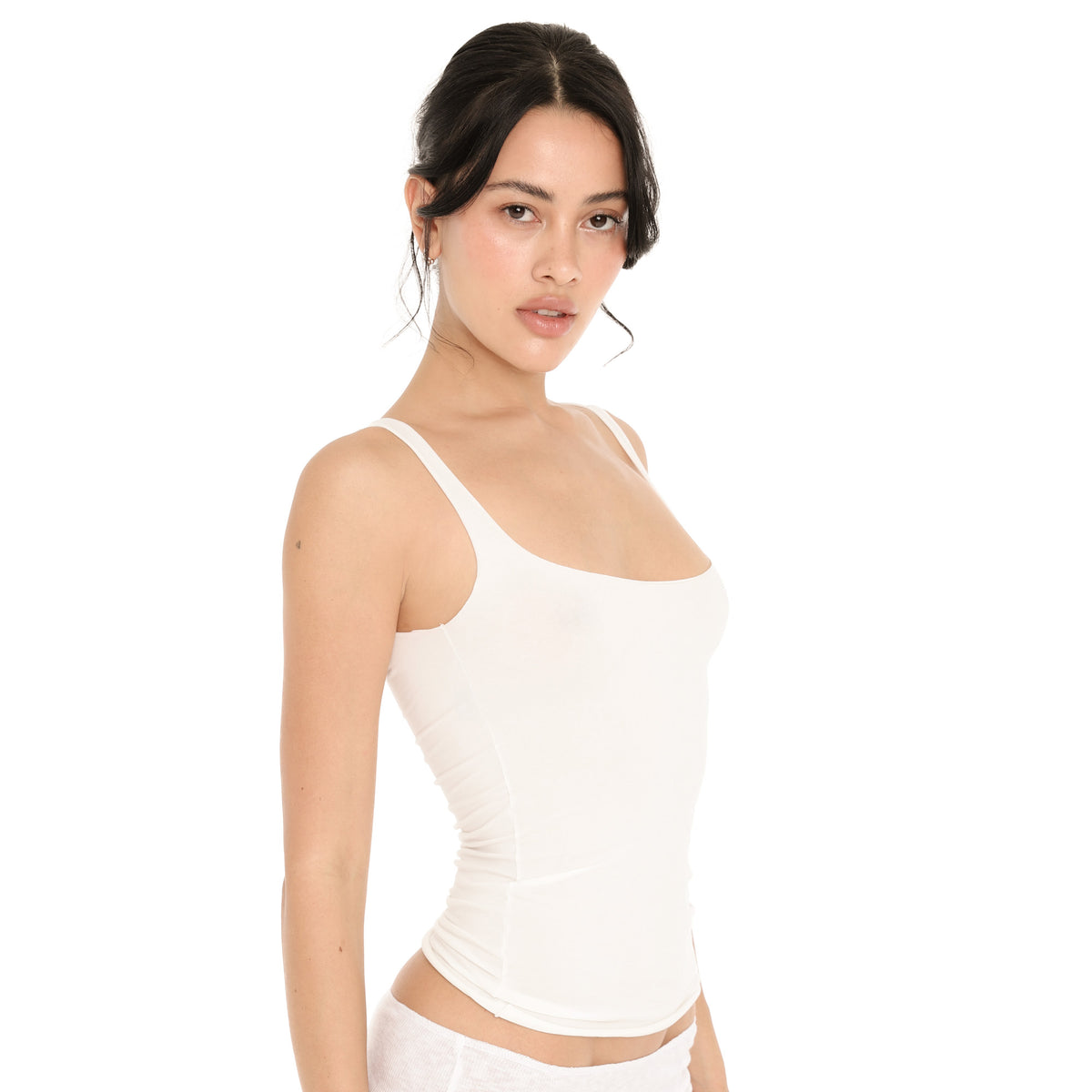 Three-quarter view of the white Elix Tank, showing the square neckline, the wide straps and the close fit through the body **white