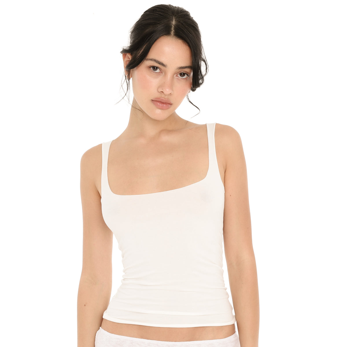 Close front view of the white Elix Tank, showing the wide square neckline, the smooth fitted body and the rolled raw hem **white