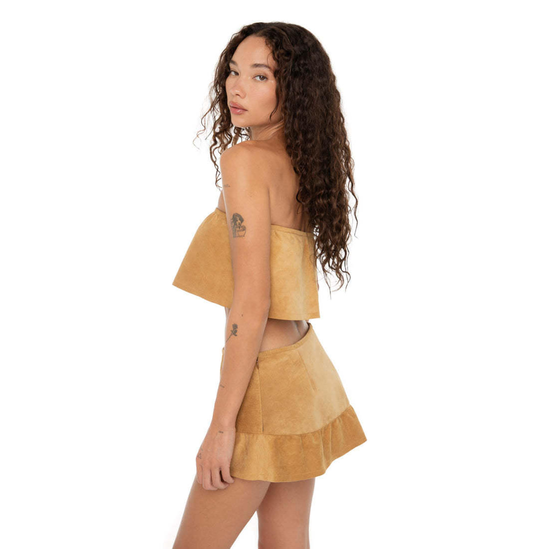 Side profile showing the flared hem of the Etra Skirt and layered drape of the Etra Top **butterscotch