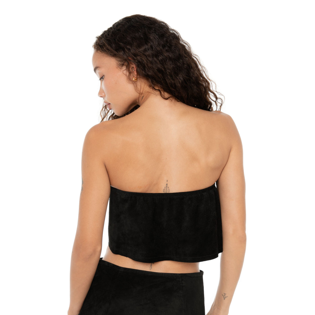 Back view of the strapless black suede top on model, showing clean silhouette and smooth finish. **black