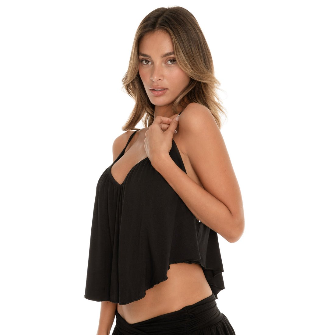 Side angle of black swing cami top highlighting soft drape, lightweight fabric, and adjustable strap construction. **black