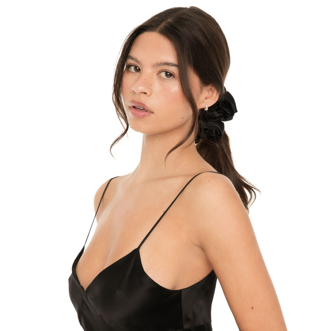 Front angle of model wearing a large black ruffled satin scrunchie in her ponytail**black