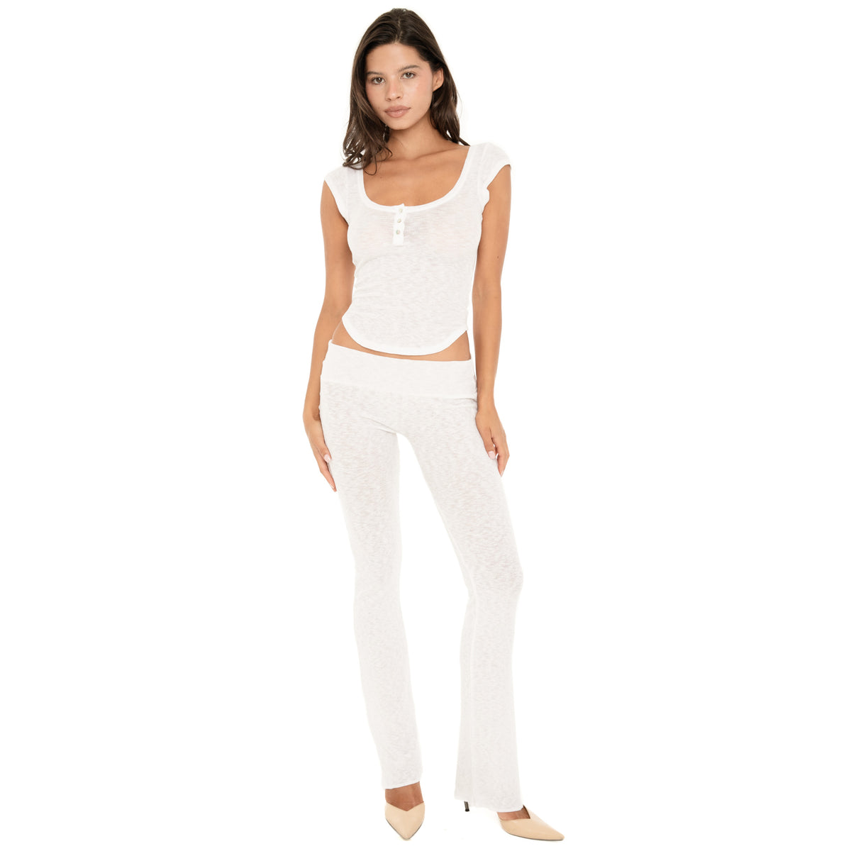 Front angled view of the Illi Pant in White, showing the low-rise fold-over waistband, fitted silhouette through the hips and thighs, and subtly flared leg **white