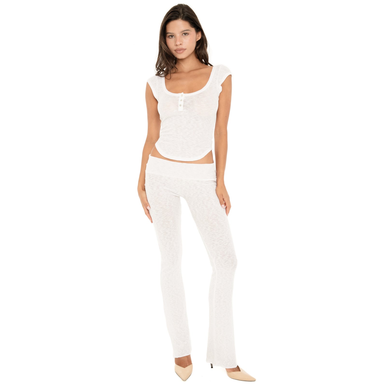 Front angled view of the Illi Pant in White, showing the low-rise fold-over waistband, fitted silhouette through the hips and thighs, and subtly flared leg **white