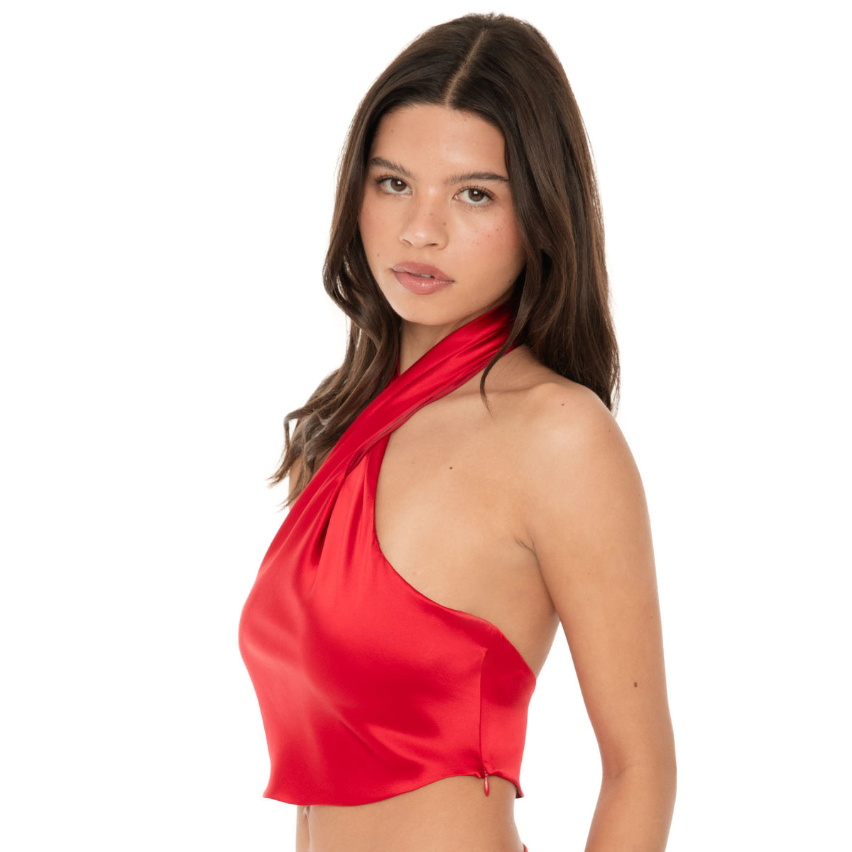 Side view of Ilta cherry red silk halter top highlighting open back and draped fit. **cherry red