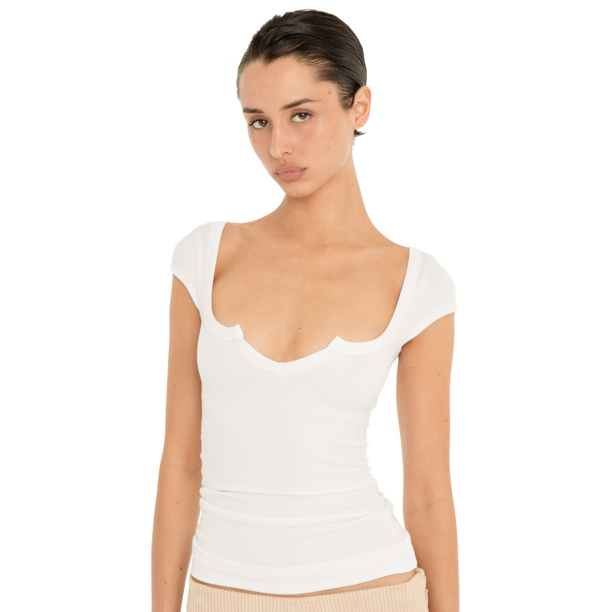 Front close-up of the white Impy Tee, showing the fitted ribbed fabric and distinctive sculpted neckline **white
