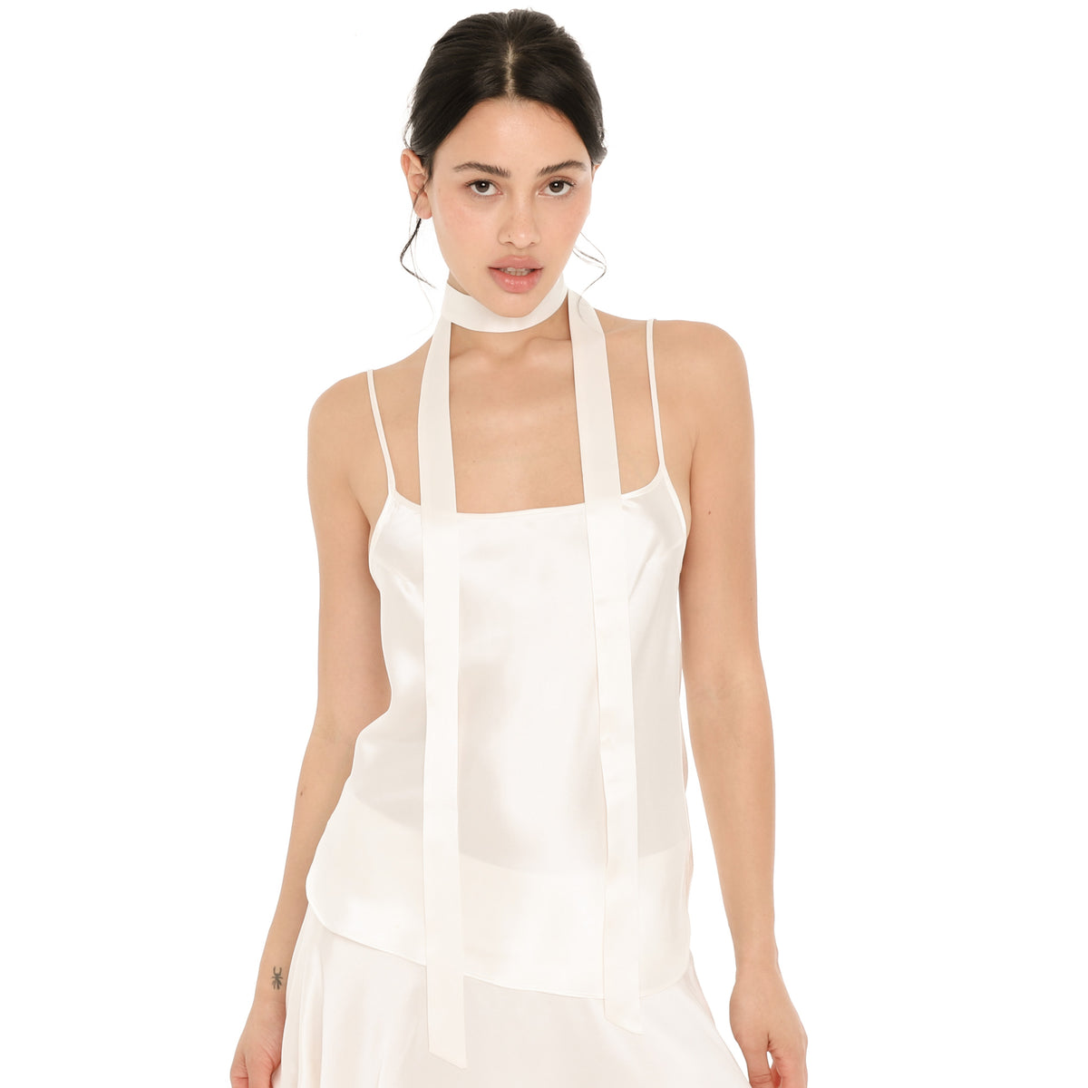 Model wearing the Isolde Scarf in white silk, wrapped once around the neck with both long ends hanging straight down the front of the white silk Syra Camisole. **white