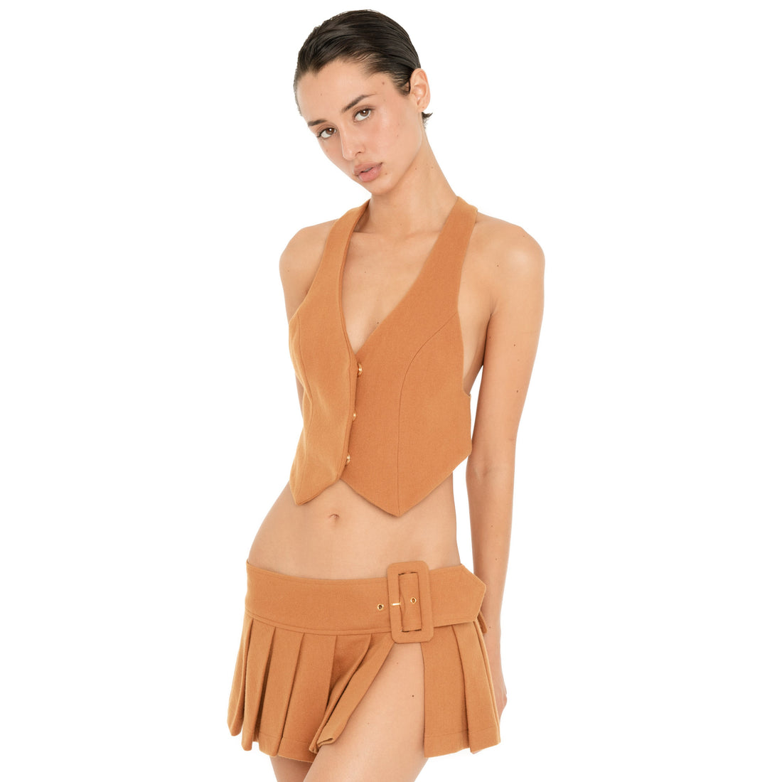 Three-quarter front view of the Kess Skirt in Saffron, highlighting the low-rise fit, oversized buckle and open side detail. **saffron