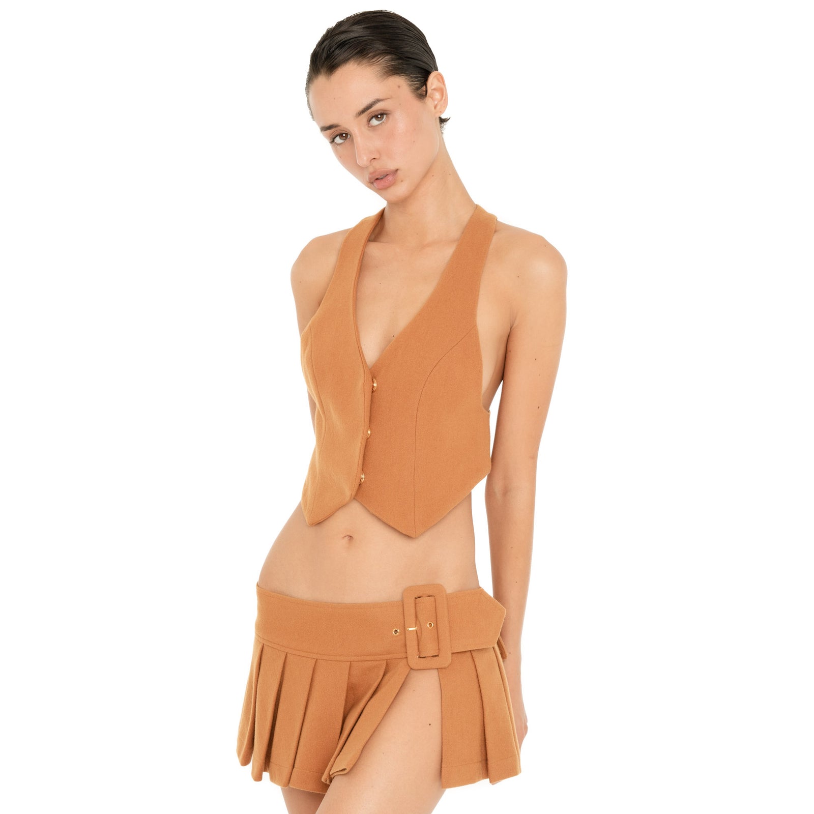 Three-quarter front view of the Kess Skirt in Saffron, highlighting the low-rise fit, oversized buckle and open side detail. **saffron