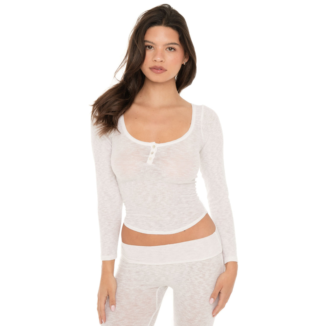 Front view of model wearing a fitted sheer white long sleeve scoop neck top with three buttons at the neckline. **white