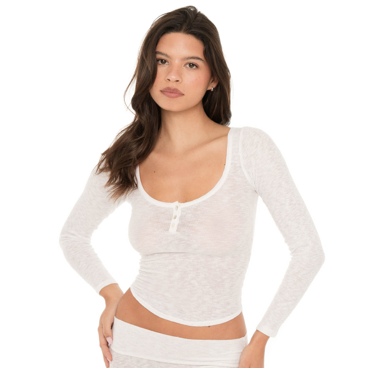 Front angled close view of model wearing a sheer white long sleeve henley top with three buttons. **white