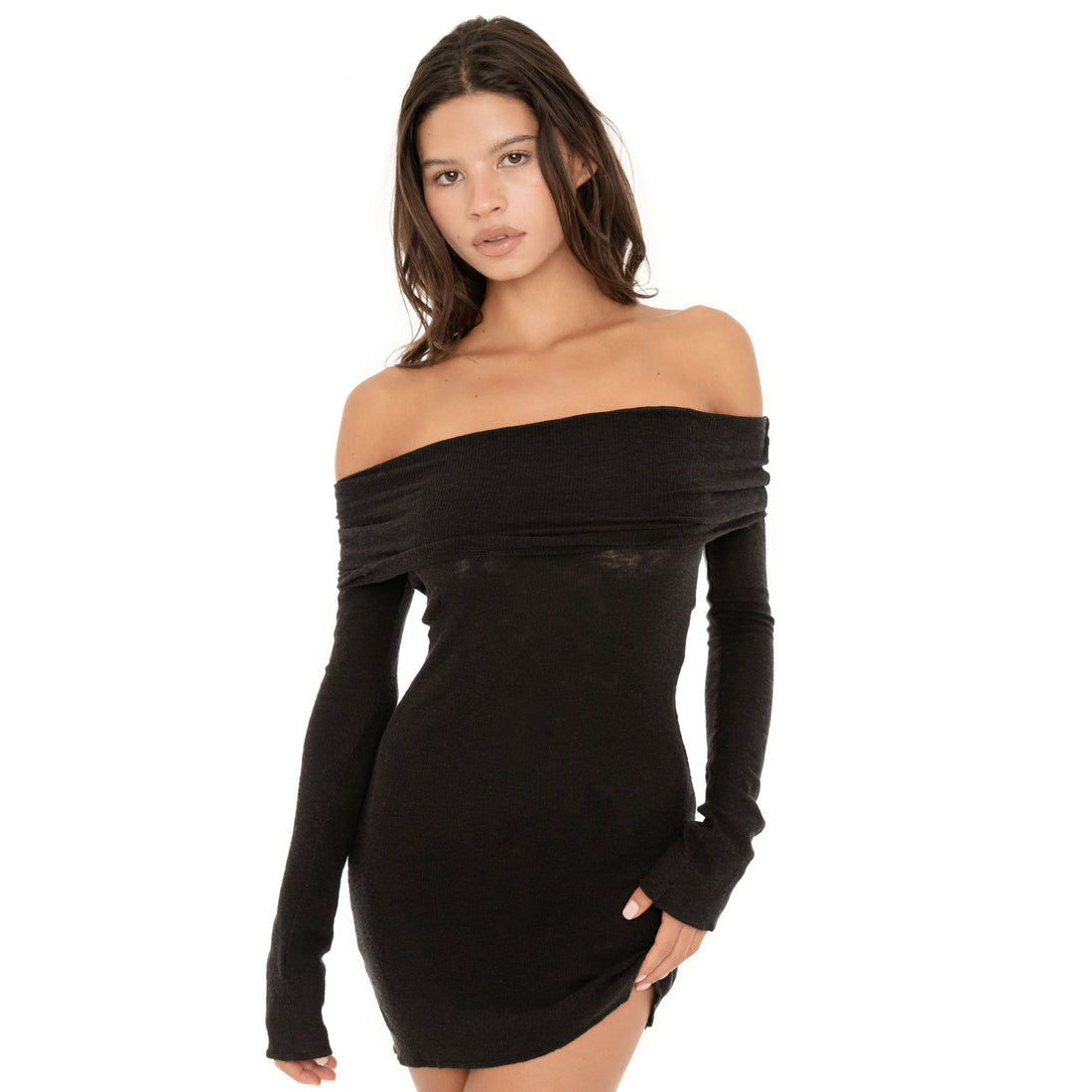 Three quarter view of the Kina Dress in black with its wide off the shoulder neckline, long sleeves and softly curved mini hem **black