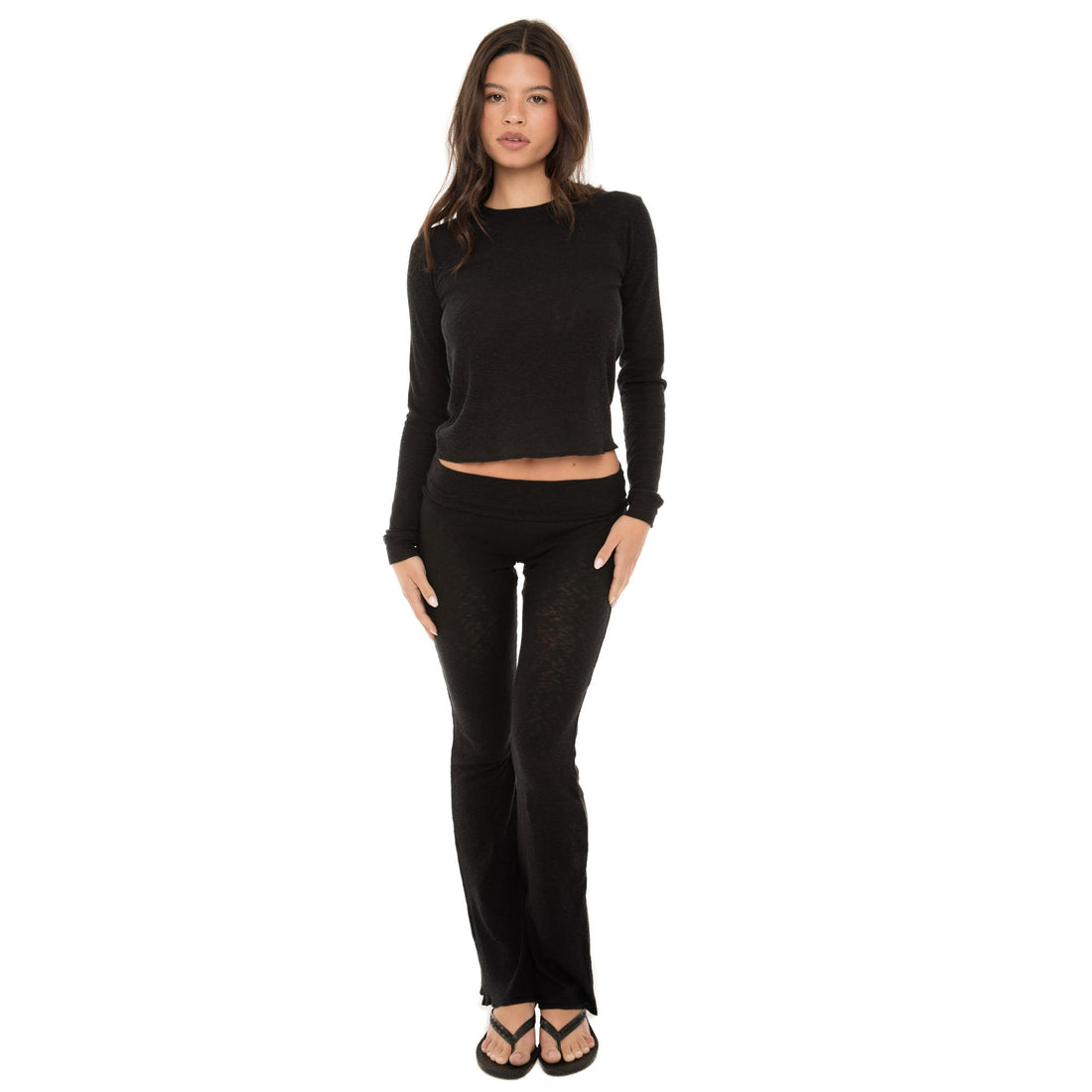 model wearing Caeli long sleeve top with crew neck, body-skimming fit, and cropped length, shown front view **black