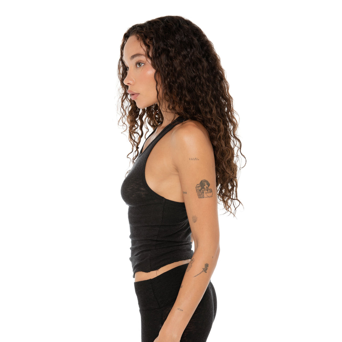 Profile view showing side silhouette of racerback cut and fit of black tank. **black