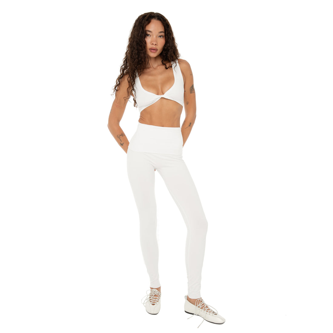 Model wearing Kixa Legging in white, high foldover waistband and seamless fit. **white