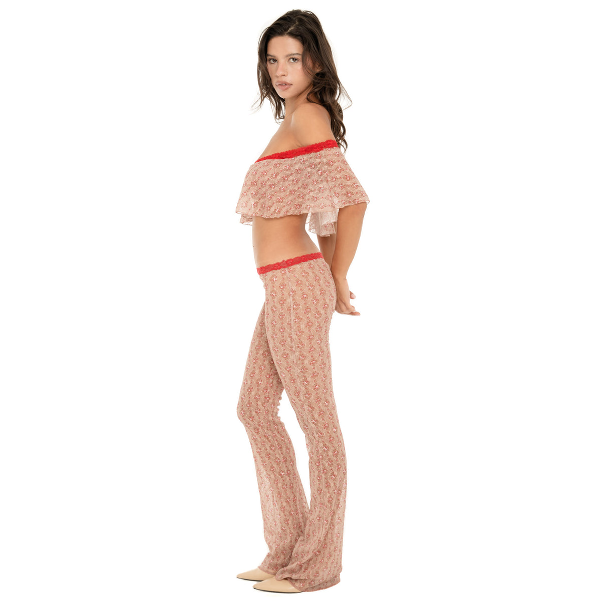 Side view of the Liani Pant in Cherry Blossom, highlighting the sheer floral lace, low-rise silhouette and long flared leg. **cherry blossom