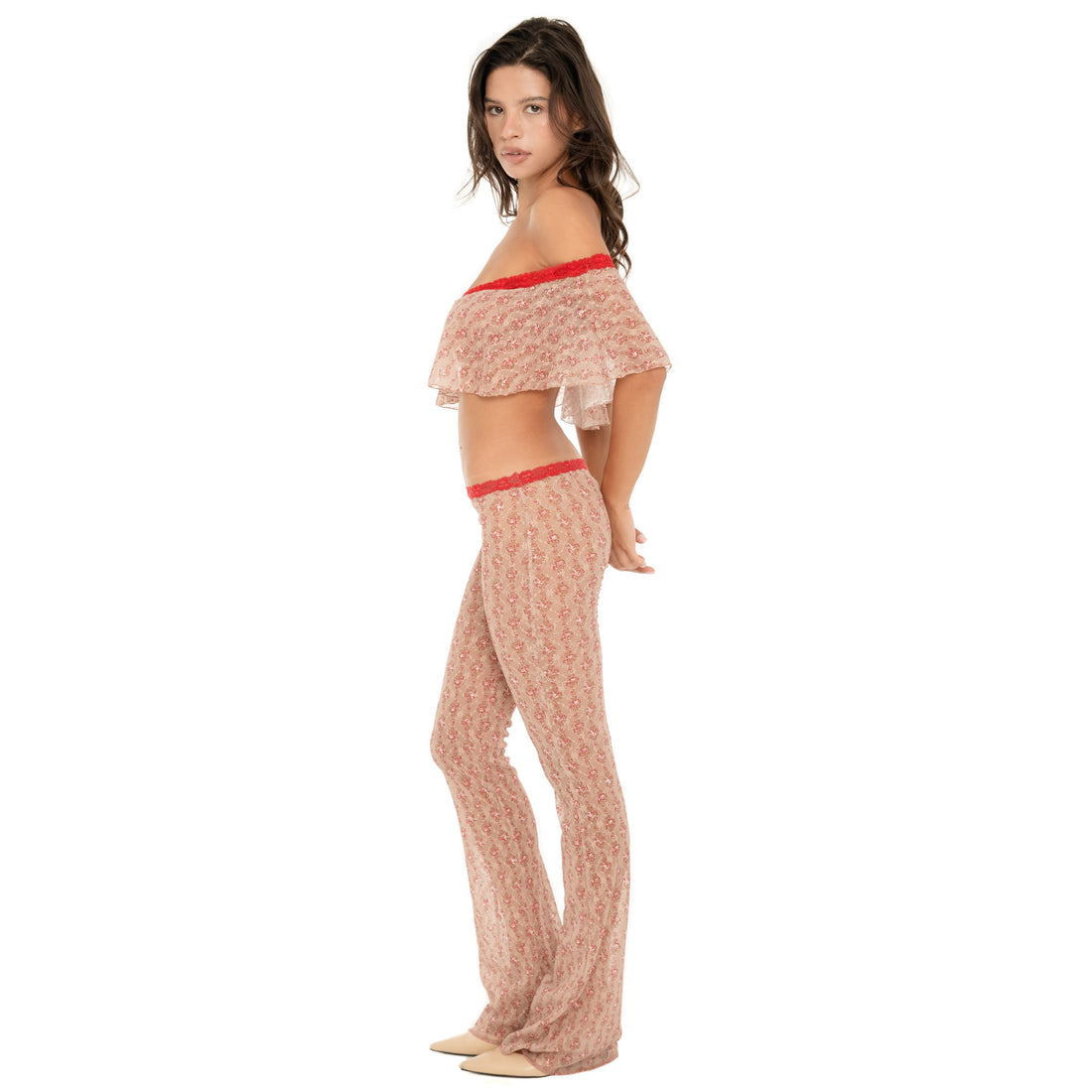 Side view of the Liani Pant in Cherry Blossom, highlighting the sheer floral lace, low-rise silhouette and long flared leg. **cherry blossom