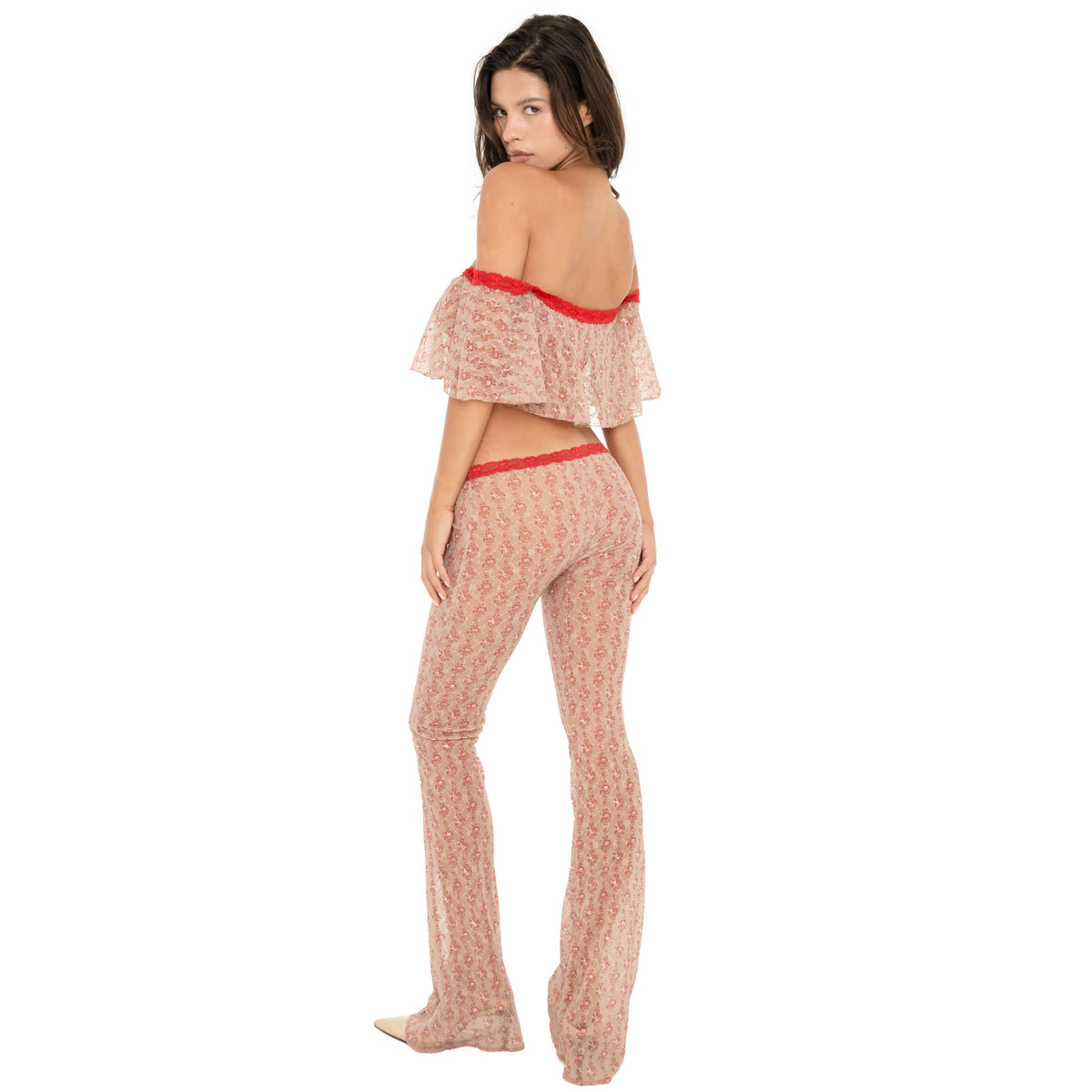 Back view of the Liani Pant in Cherry Blossom, showing the sheer floral lace, red lace-trim waistband and fitted-to-flared silhouette **cherry blossom