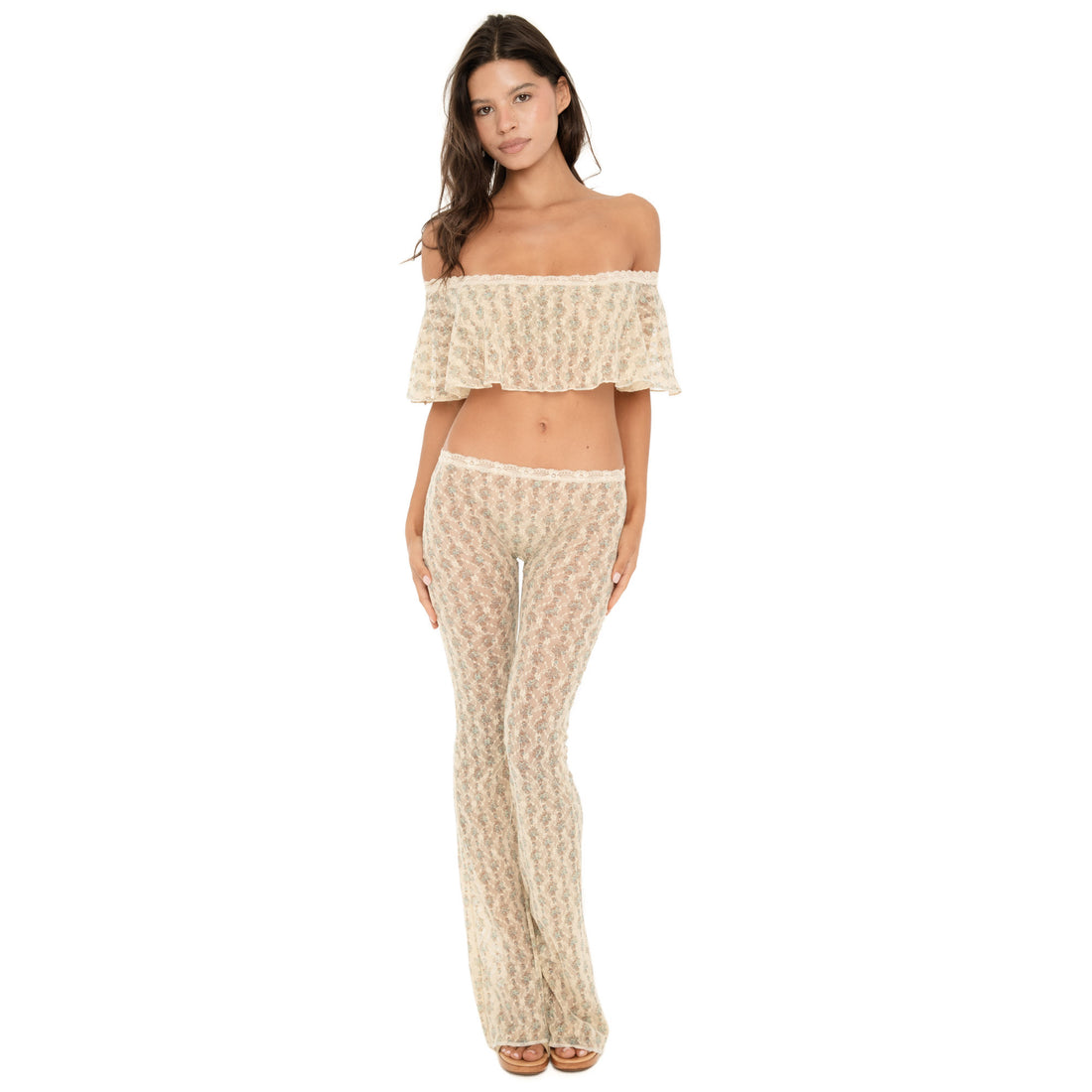 Model wearing the Liani Pant in Sky Blossom, a sheer floral lace low-rise pant with a slim flared leg and ivory lace-trim waistband, styled with a matching off-the-shoulder top **sky blossom