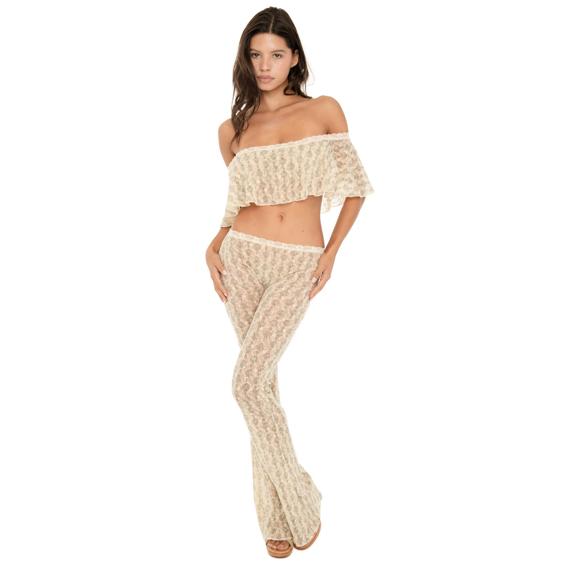 Front three-quarter view of the Liani Pant in Sky Blossom, showing the sheer floral lace, low-rise fit, ivory lace waistband and flared leg **sky blossom