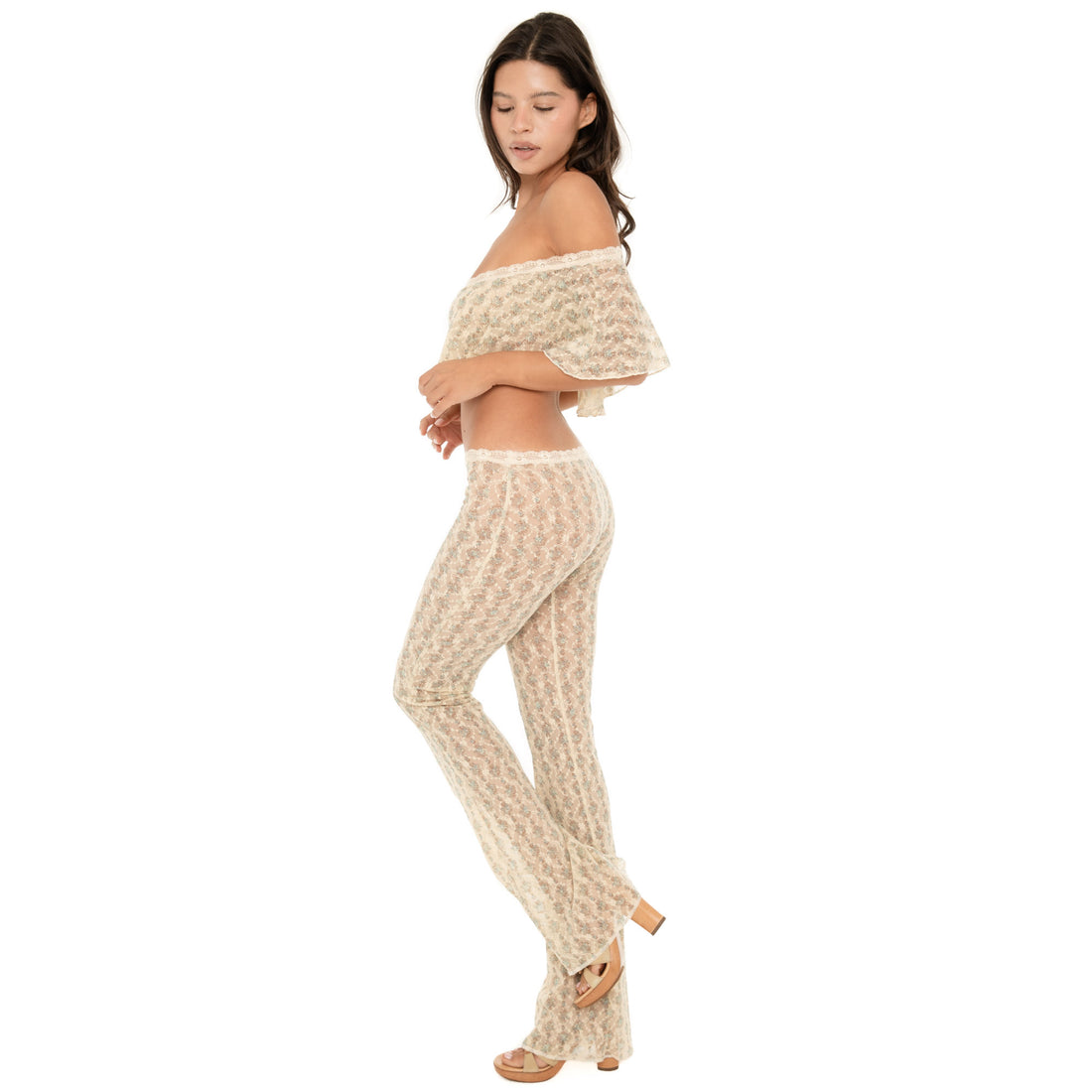 Side three-quarter view of the Liani Pant in Sky Blossom, highlighting the sheer floral lace and fitted-to-flared silhouette **sky blossom