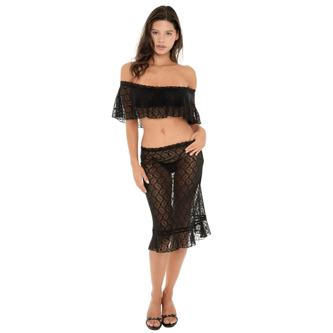 Model wearing the black Liulu Skirt, a sheer floral lace midi skirt with a low-rise waist and ruffled hem, styled with a matching lace top  **black