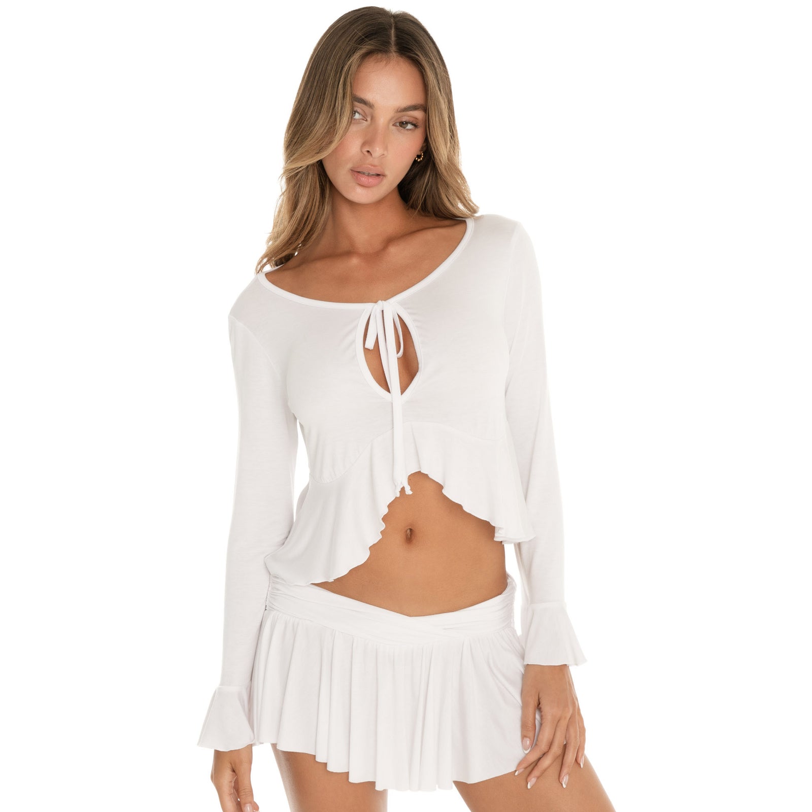 Angled side view of white Lunet top highlighting cropped silhouette and flared sleeve cuffs **white