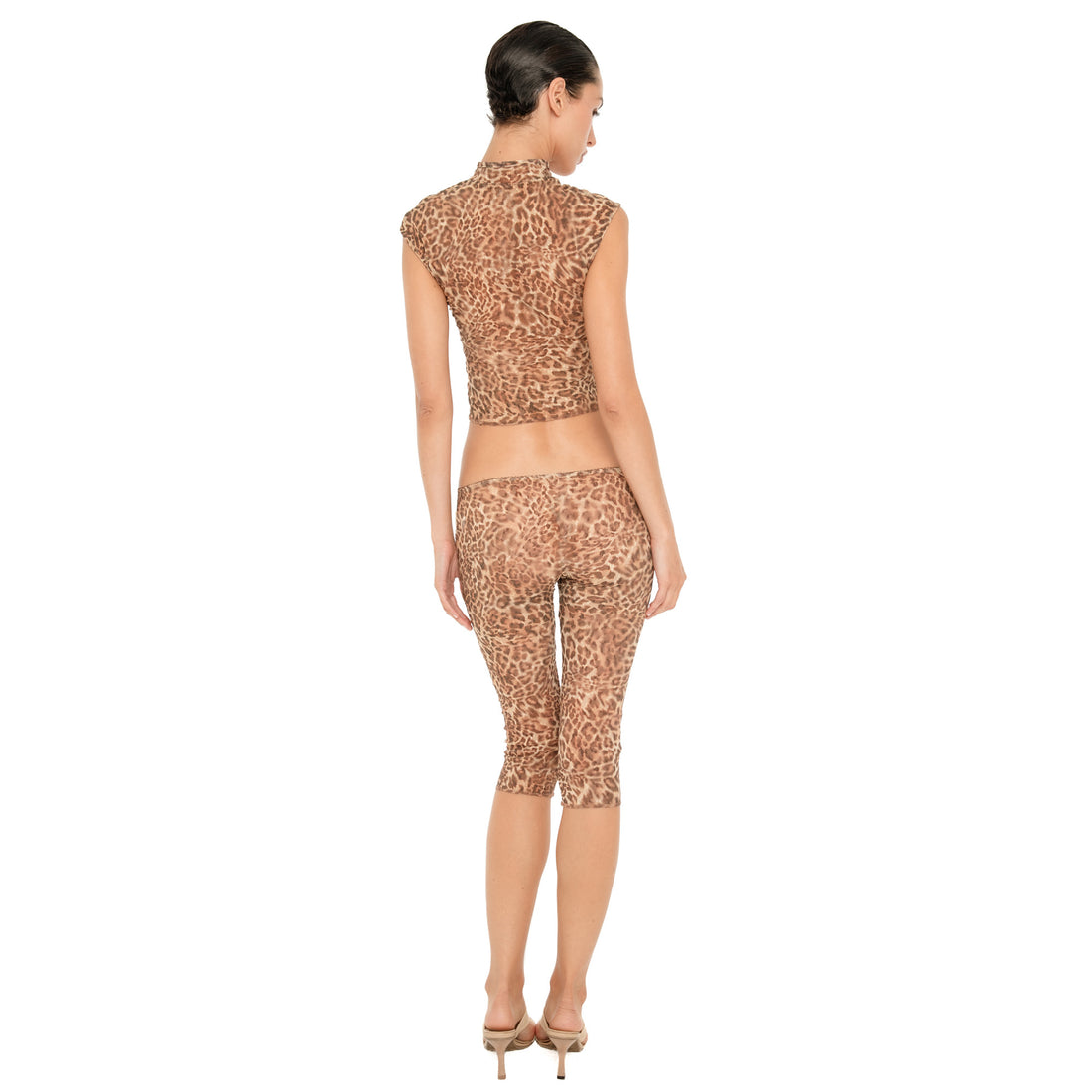 Back view of model wearing the Lyli Capri in sheer brown leopard print, showing the low rise fit and fitted cropped silhouette from behind