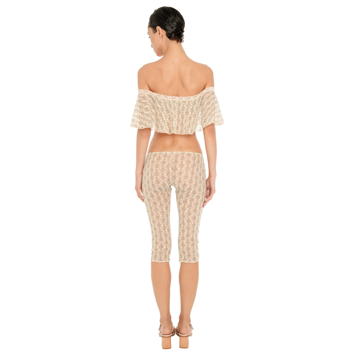 Back view of the cream sheer floral lace Lyli Capri, showing the sheer floral pattern, low rise waist, and fitted knee length silhouette, worn with the matching off shoulder top. **sky blossom