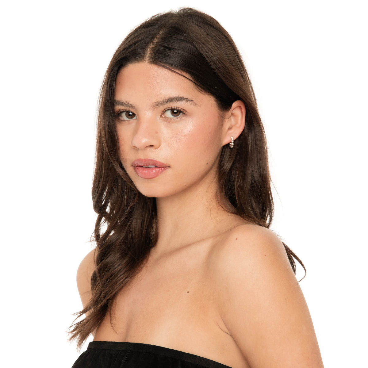 Close-up of model wearing Lyth hoop earrings in sterling silver, showcasing the smooth rounded beads and subtle shine.