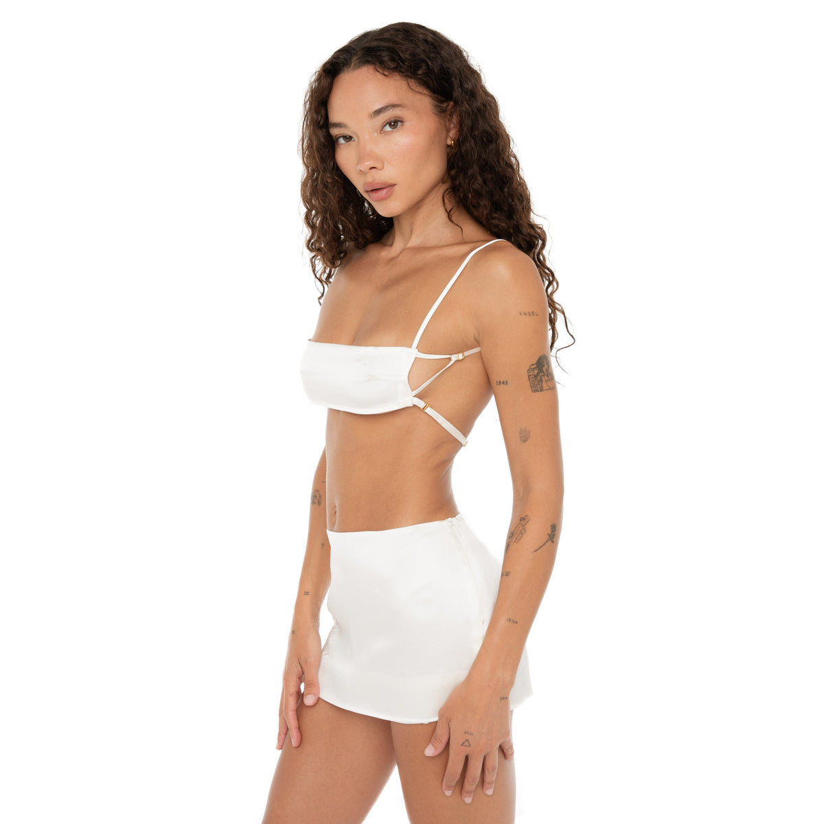 Side angle view of model in Missi Bra white silk charmeuse with cut-out strap details. **white