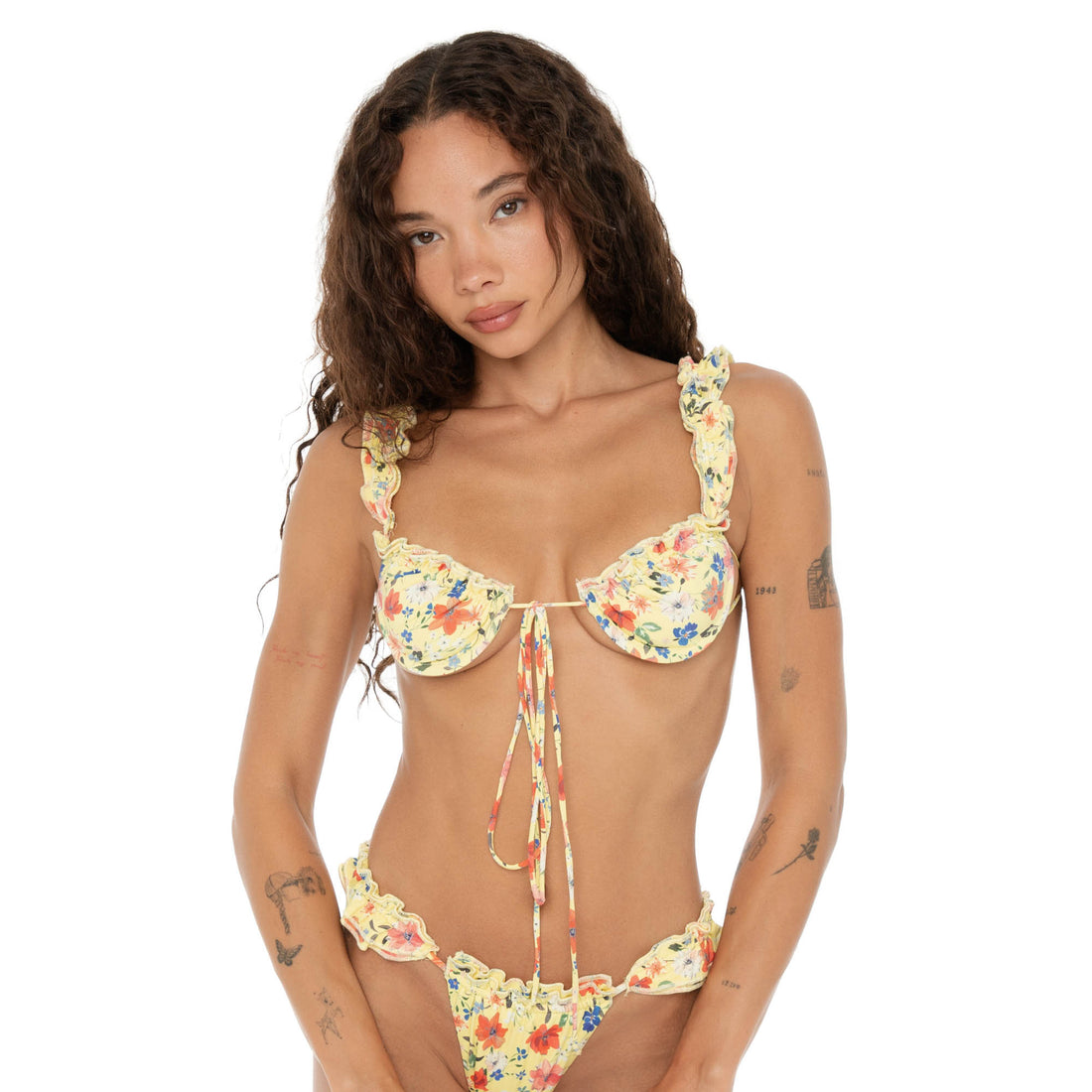 Front close-up of model in the Are You Am I Nesi Swim Top Lemon Blossom, highlighting ruffle trim details and tie-front adjustable straps. **lemon blossom