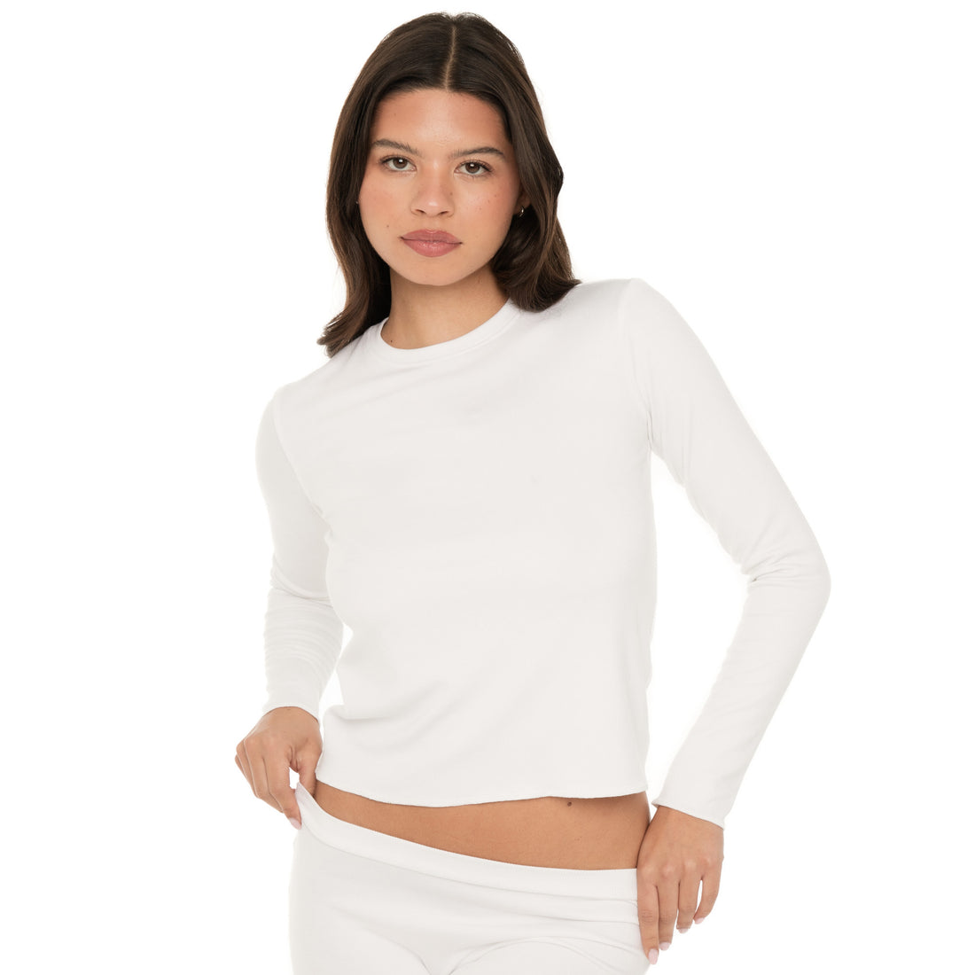 Close-up front view of model wearing the NIIMA Top in white, showing the soft fitted silhouette and overlock hem.**white