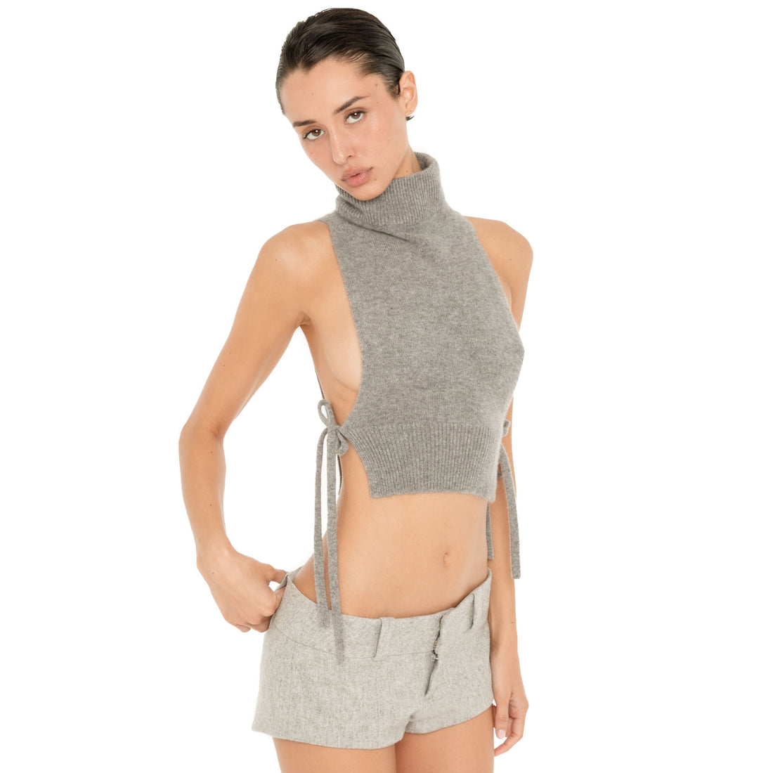 Front three-quarter view of the Nula Short in Dove, showing the wide low rise waistband, belt loops and fitted micro length. **dove