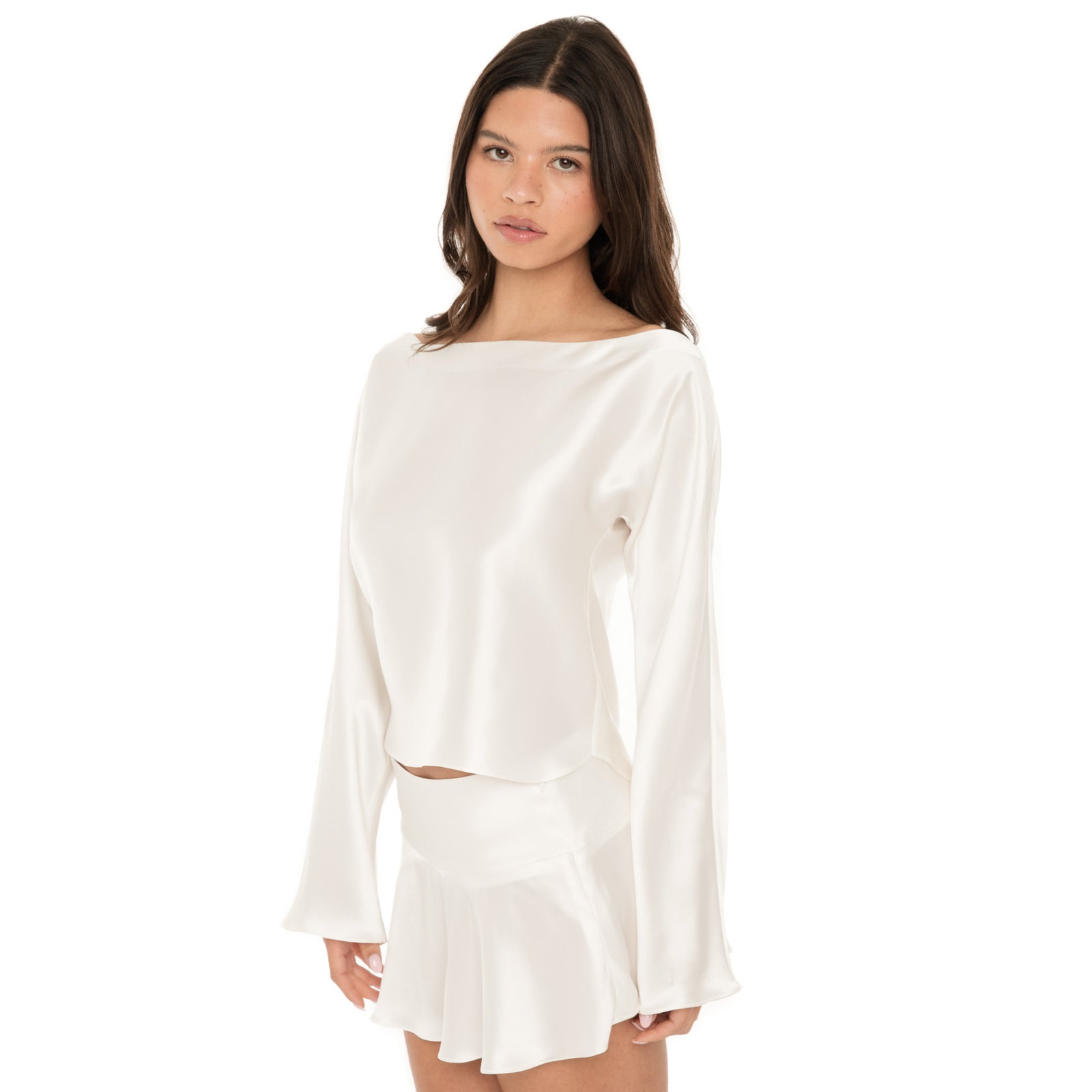 Three-quarter front view of the white silk boatneck blouse showing smooth neckline and soft sheen. **white