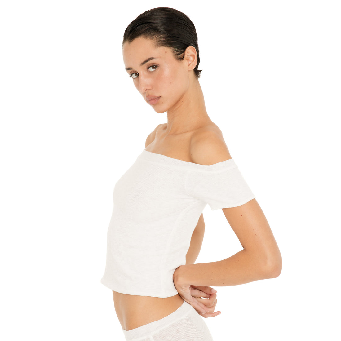 Side view of the white Solei top, showing its fitted silhouette, short sleeves, and wide off-the-shoulder neckline **white